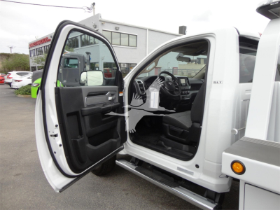 Ram 5500 HD SLT cab interior with front door open, showing steering wheel, dashboard, and front seat area.