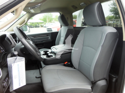 Interior of a 2023 Ram 5500 HD SLT front seats with gray cloth upholstery and center console visible