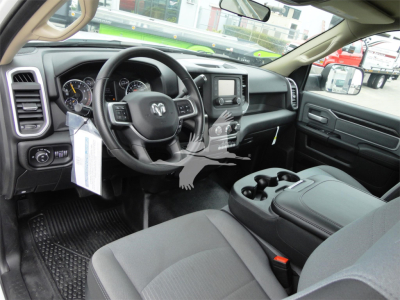 Ram 5500 HD SLT interior showing steering wheel with RAM logo, center console with touchscreen, and front seats with cup holders.