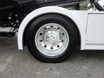 Ram 5500 wheel and fender with chrome hubcap and white body panel visible.