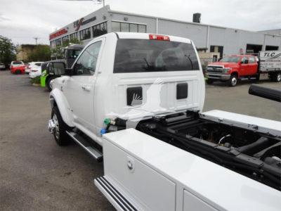 Ram 5500HD pickup truck back view showing cab and flatbed/rollback equipment with attached toolboxes and chrome steps.
