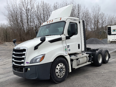Freightliner Cascadia126 daycab tractor showing side view with white cab, dual rear axles, and raised sleeper/panel on top.