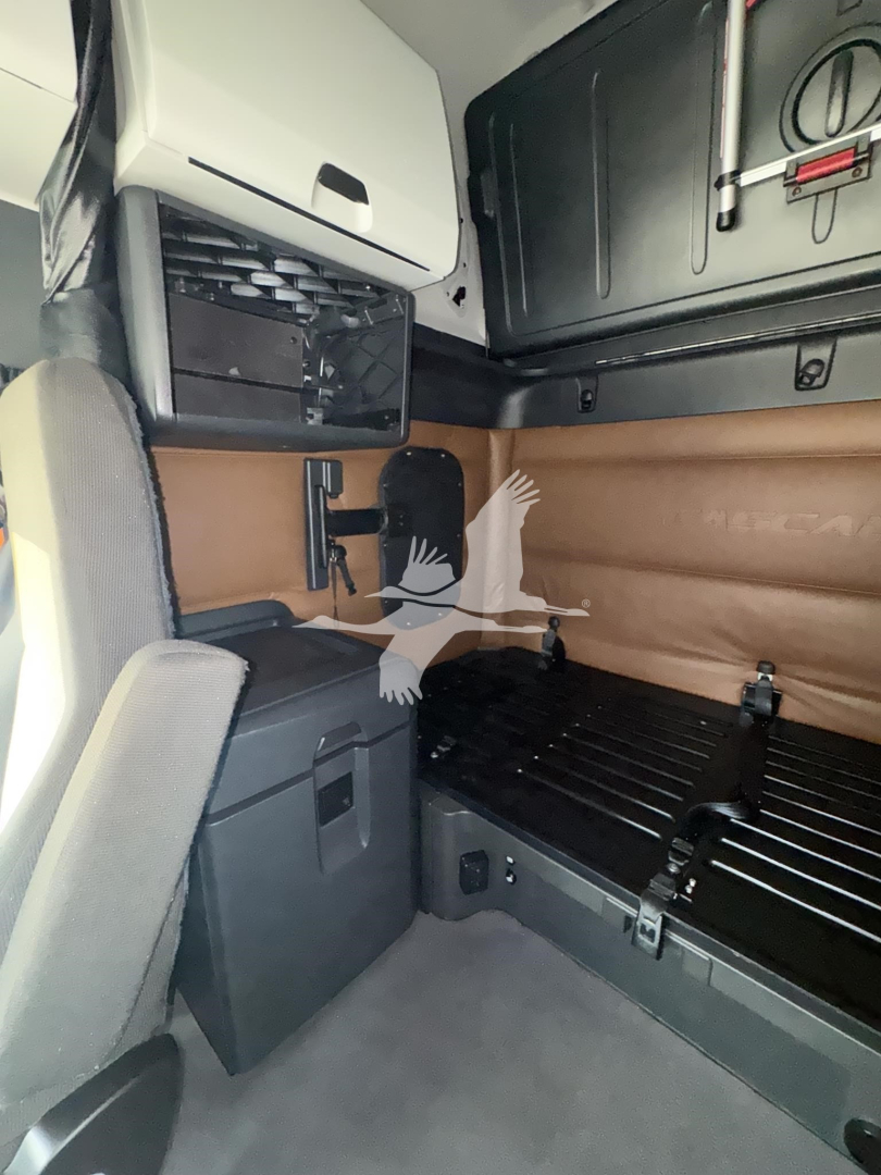 Freightliner Cascadia 126 cab interior showing sleeper area with storage cabinet and bed platform