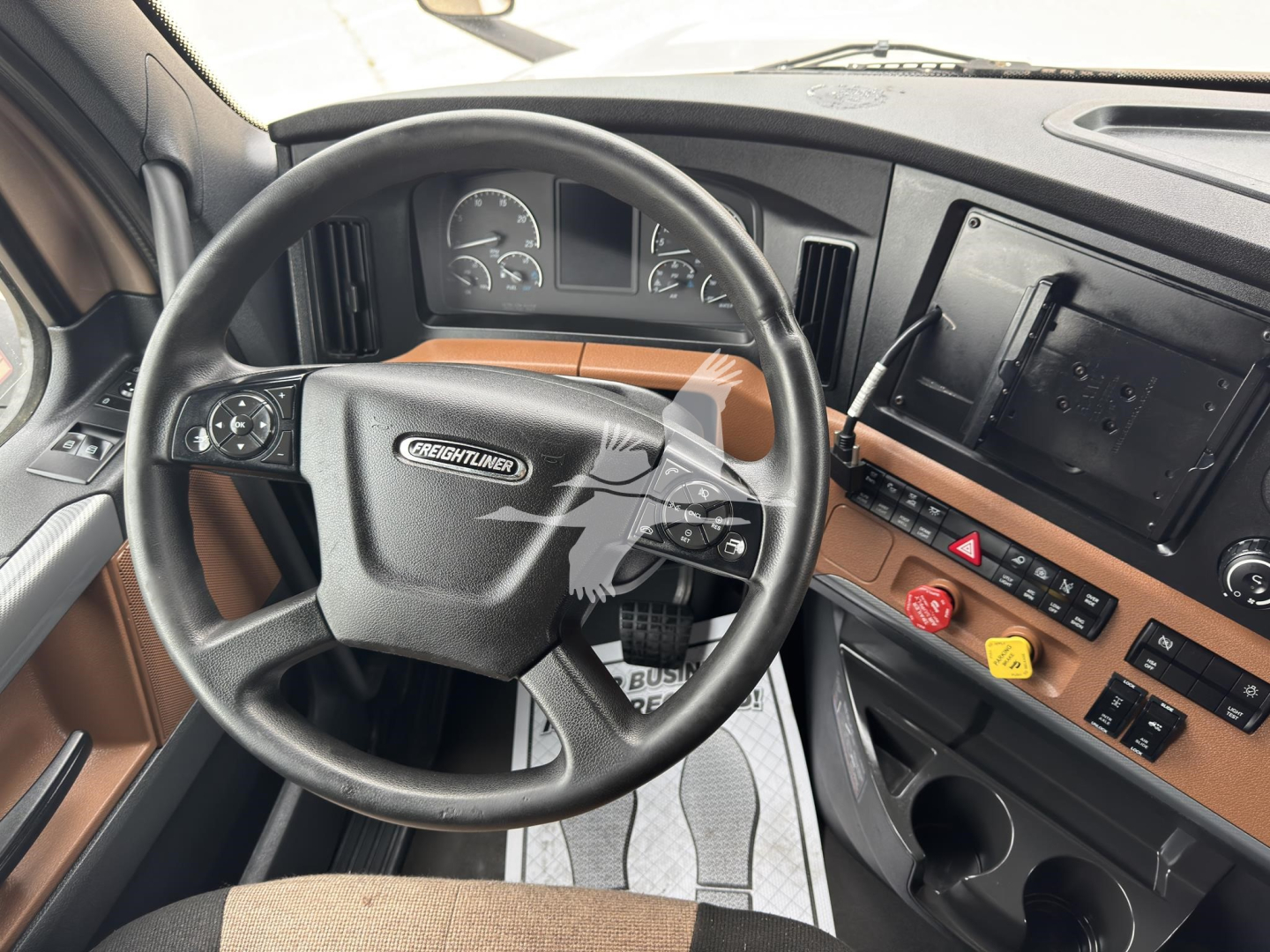 Freightliner Cascadia 126 truck interior showing steering wheel and dashboard with center console controls.