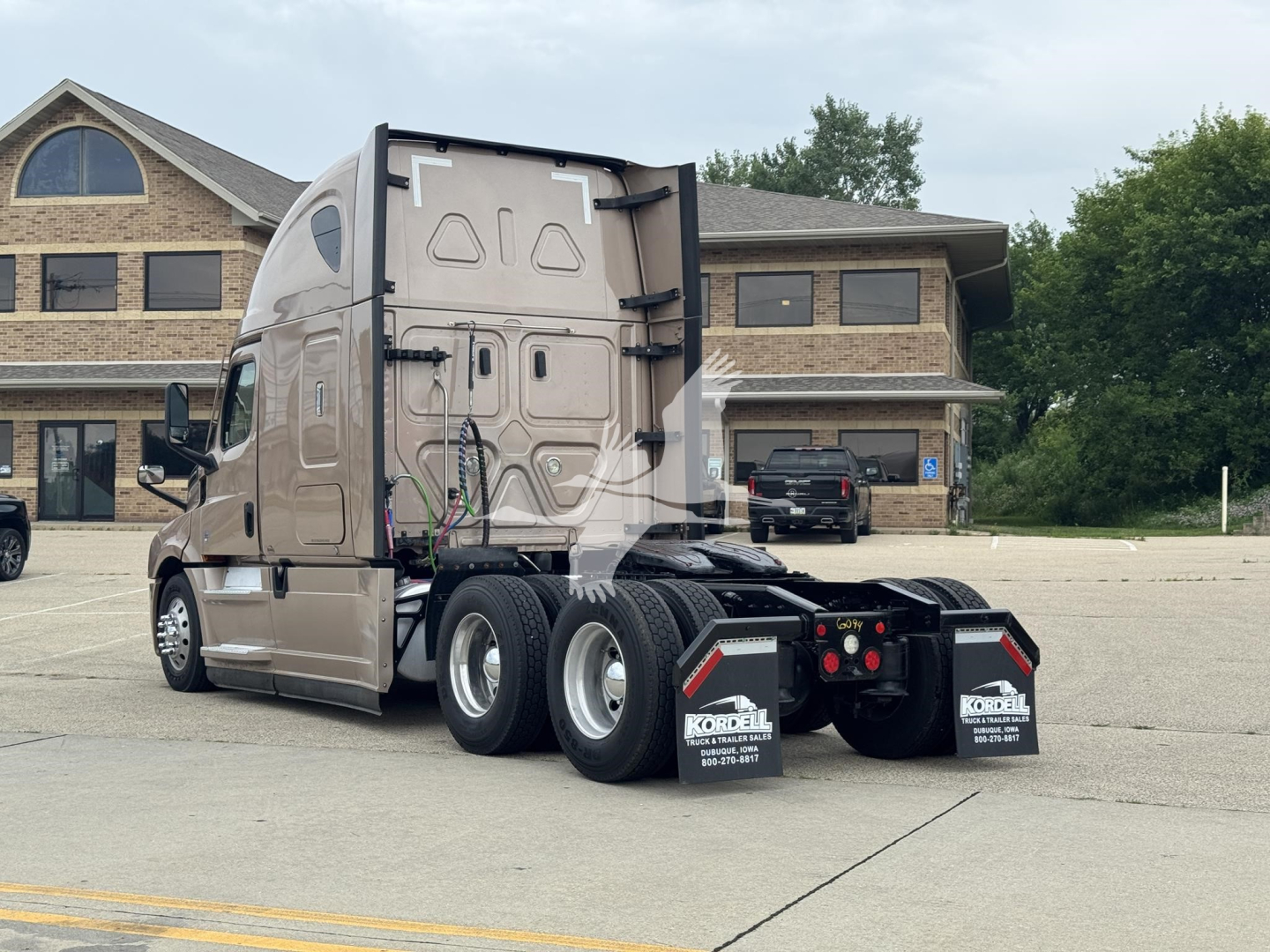 Truck rear/side view showing Freightliner Cascadia 126 with sleeper cab and dual rear axles.