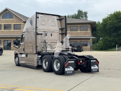 Truck rear/side view showing Freightliner Cascadia 126 with sleeper cab and dual rear axles.