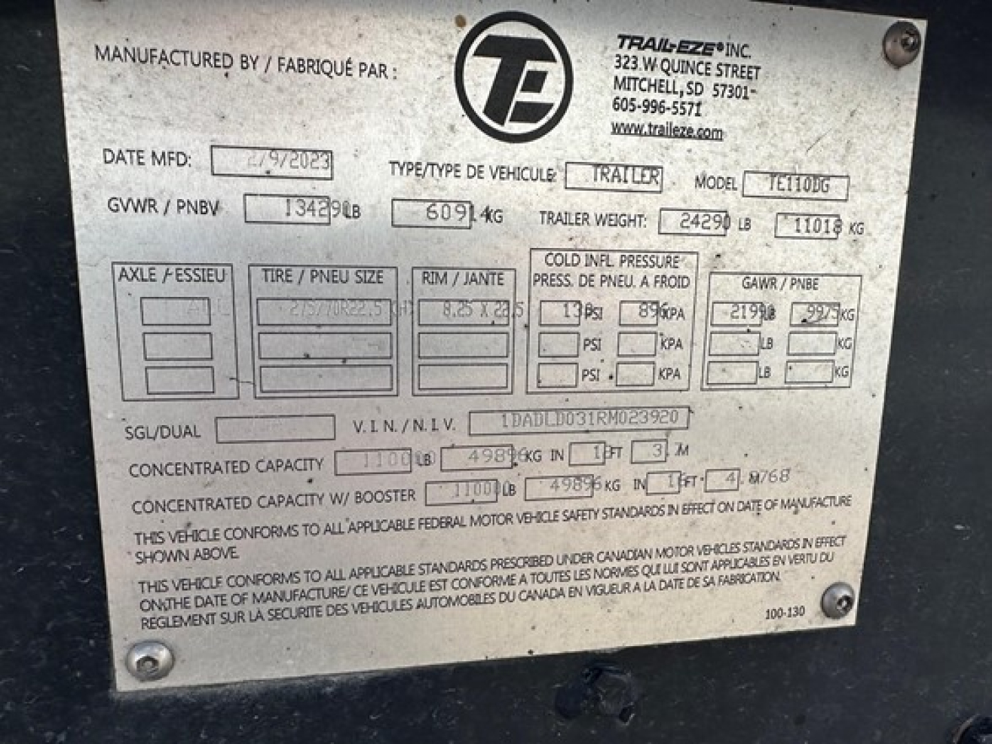 Trailer plate showing Manufacturer info, GVWR, GAWR, model TE110DG, serial number, and weights for Trail-Eze trailer.