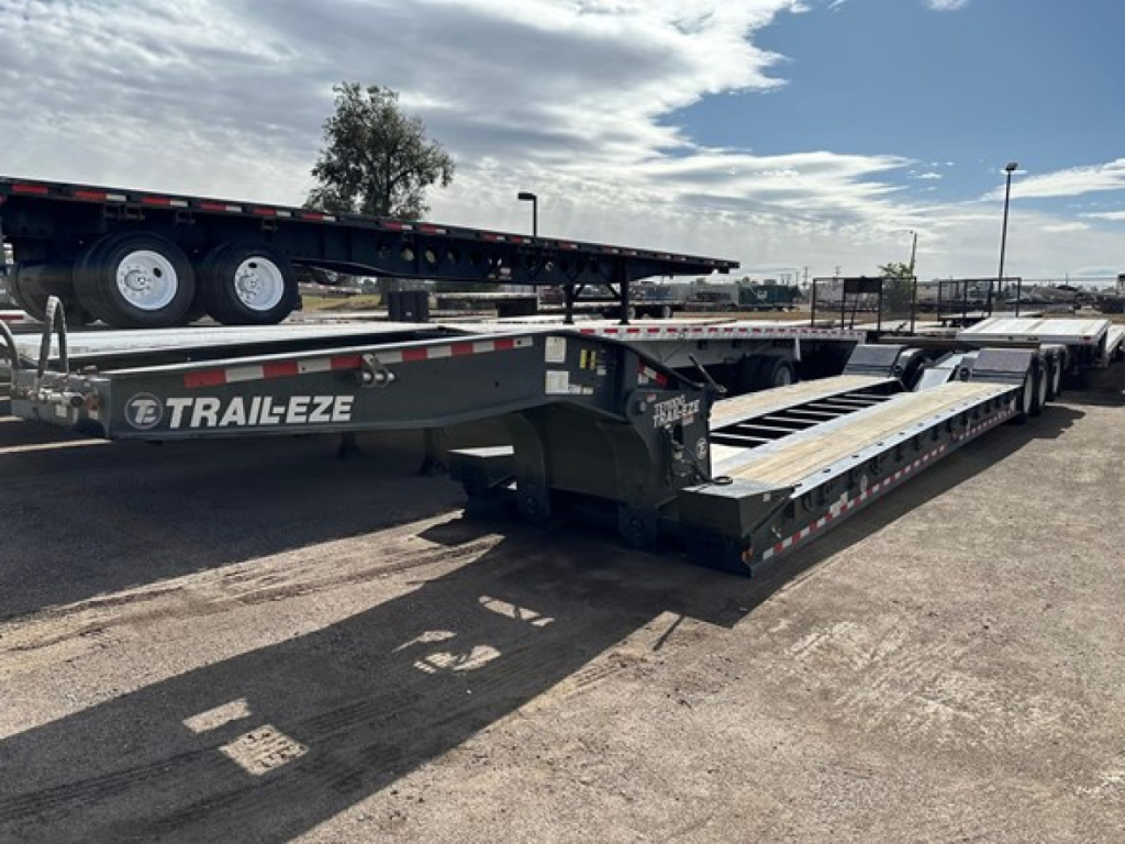 Trail-Eze TE110DG lowboy trailer showing side rails and deck with Trails-Eze branding visible.