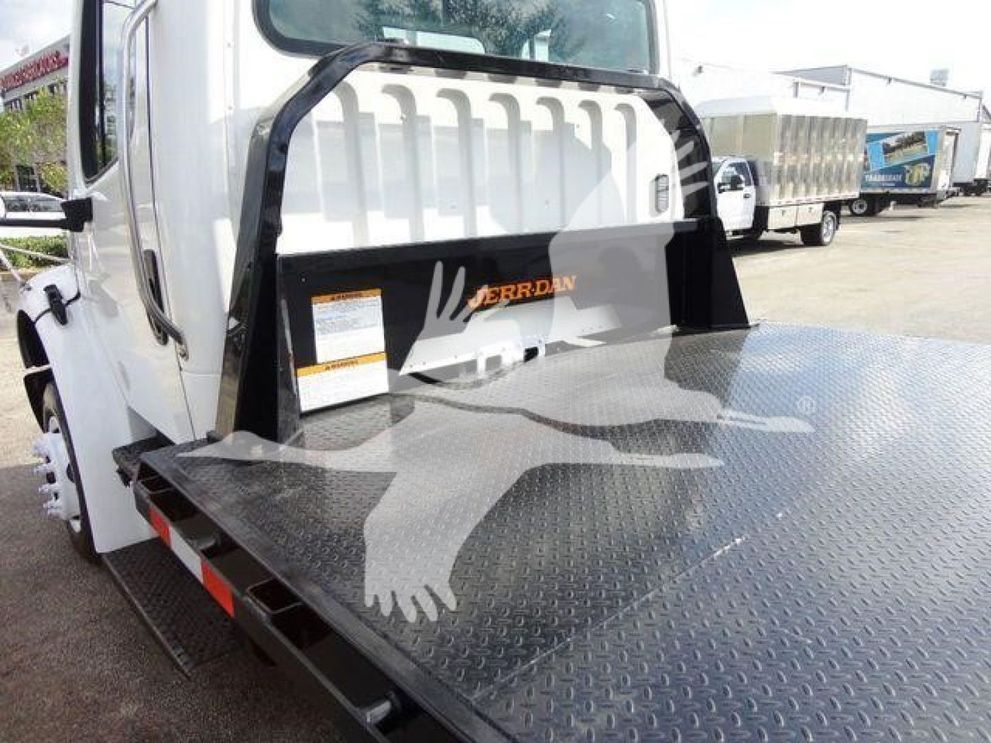 Flatbed Freightliner M2 106 truck entry with diamond plate bed and rear step showing scraped graphics and cab access.