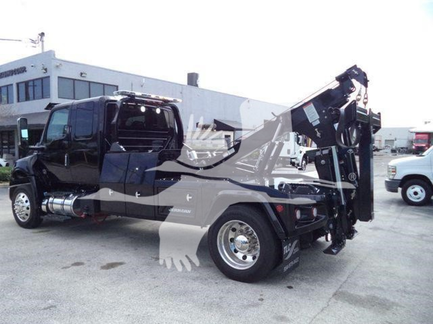 International MV truck with crane/winch attached, side view showing cab and rear hydraulic arm, stock number J78070