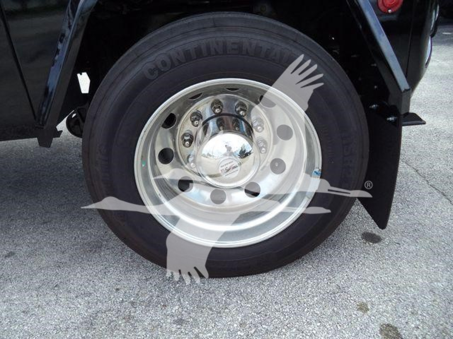 Truck wheel with Continental tire and steel rim, undercarriage detail visible.