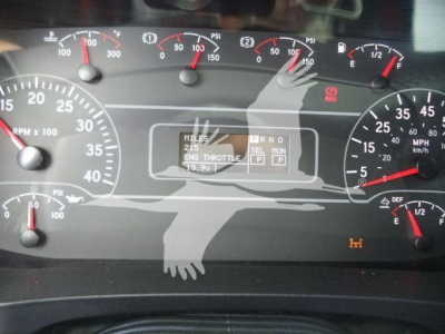 Dashboard of a 2025 International MV truck showing multiple gauges, digital readout, and warning lights.