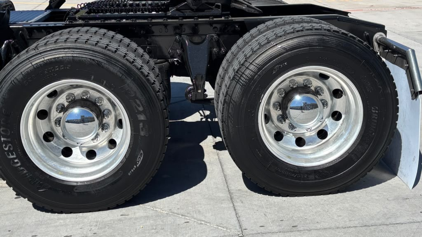 Dual rear wheels of a heavy-duty truck trailer/tractor showing chrome hubs and Bridgestone tires.