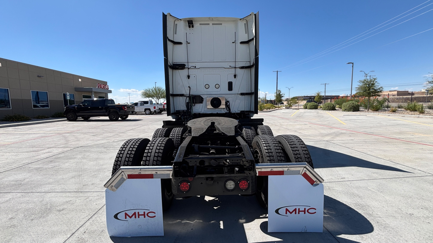 Rear view of a 2022 International LT625 sleeper truck showing rear axle dual wheel arrangement, fifth wheel area, and mud flaps with MHC logos.