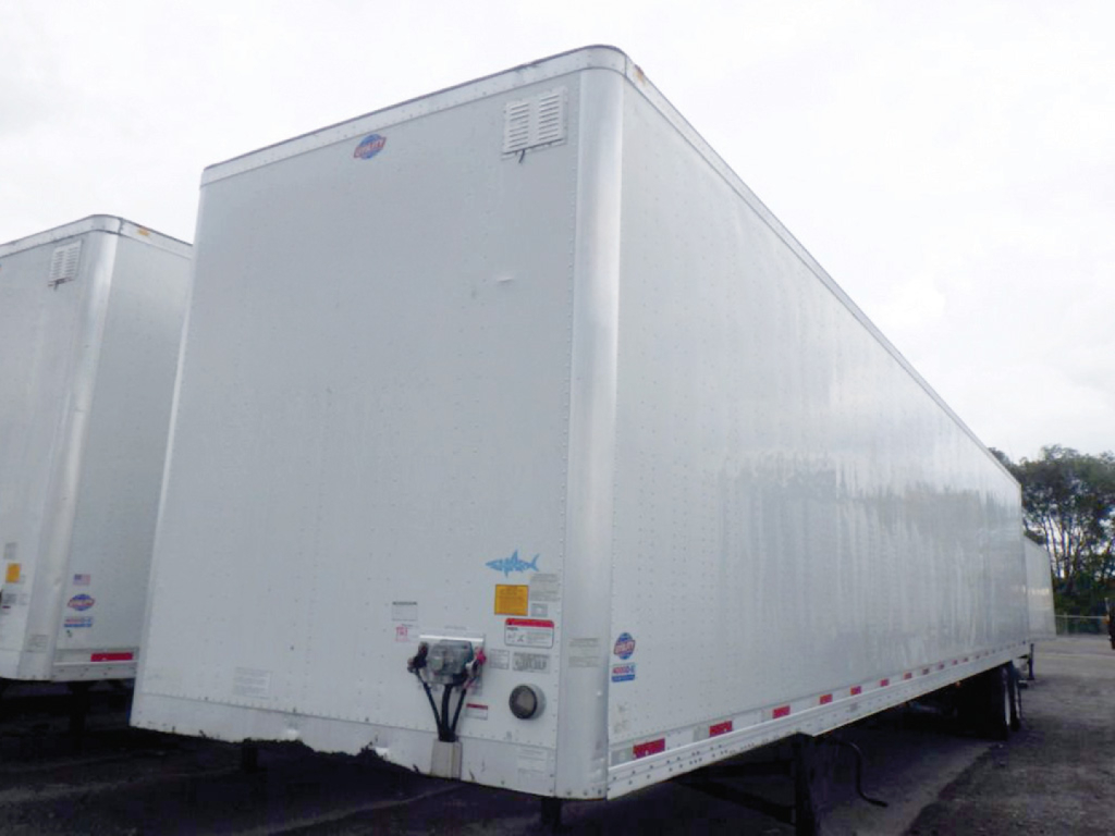 Utility dry van trailer side/front view showing exterior white panels, rear door hardware and reflective tape along base line.