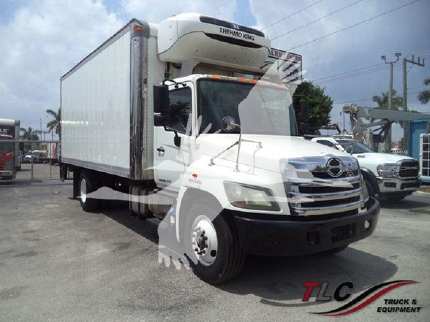 Hino 268a refrigerated truck with Thermo King unit, white cab, side view showing cargo box and front grille.