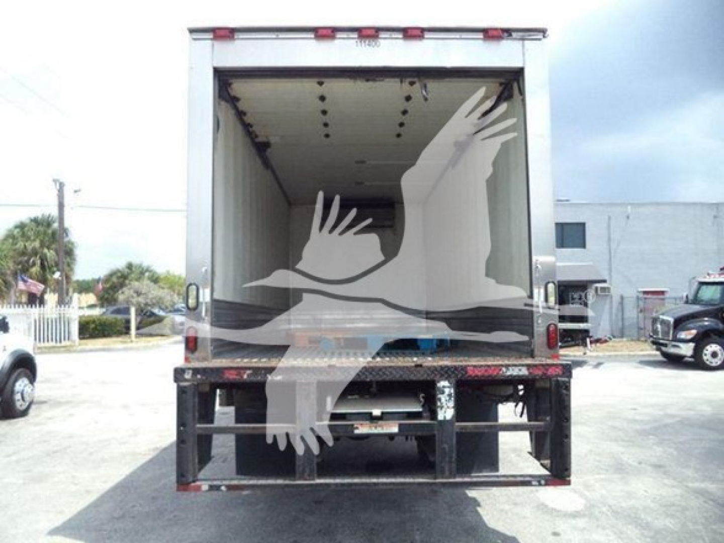 Hino 268a refrigerated truck cargo area with open rear doors, stock number 200151R.