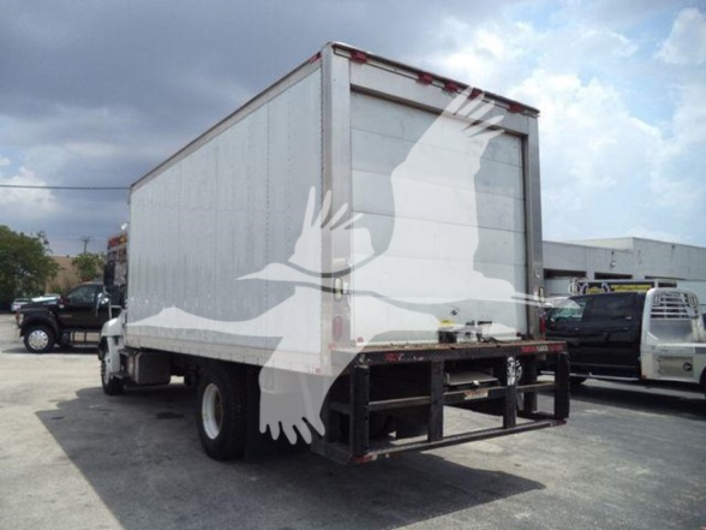 Hino 268a refrigerated truck from rear-left view showing cargo box and rear bumper.