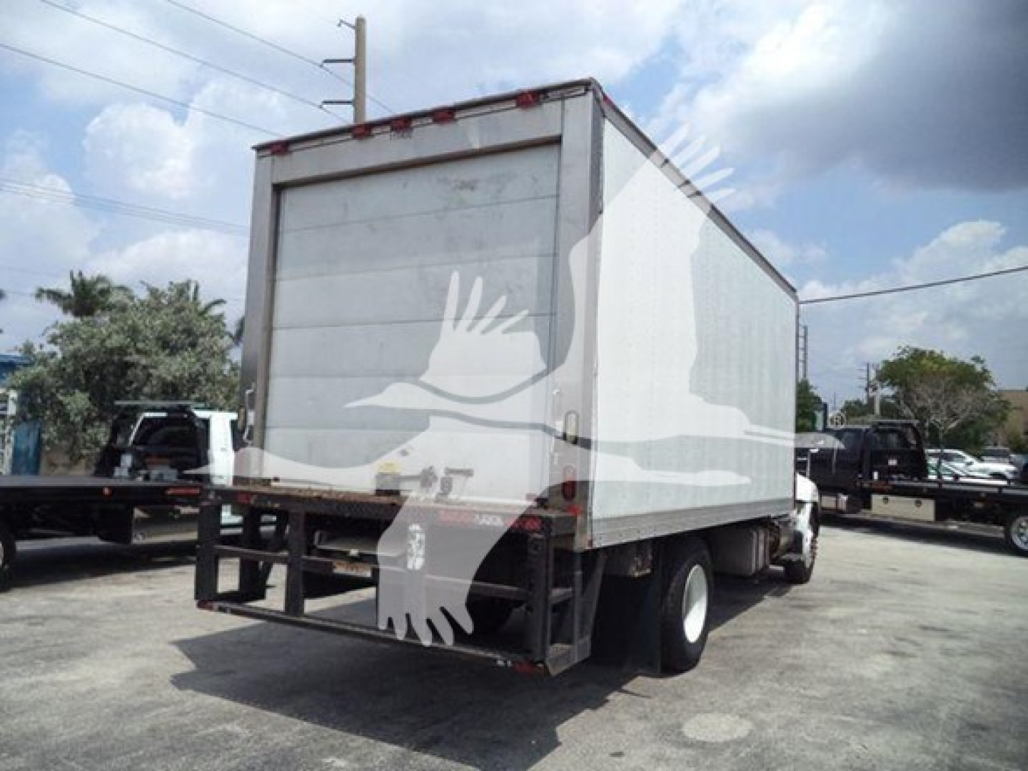Truck rear and side view showing refrigerated box on a Hino 268a chassis with rear doors and dual rear wheels.