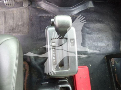 Gear shift lever area of a 2015 Hino 268a with R N D 2 1 0  from top view and surrounding floor mats.