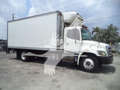 2015 Hino 268a refrigerated truck with a large box body and refrigeration unit on cab roof, side view.