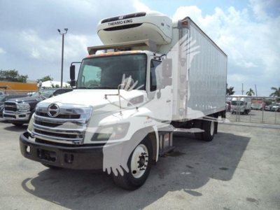 2015 Hino 268a refrigerated box truck with Thermo King unit on cab-over front, white cab, large white box trailer, parked in lot.