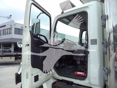 Hino 268a cab interior and open door showing steering wheel and seating area.
