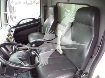 Trucks interior showing driver seat and passenger seat in a refrigerated 2015 Hino 268a cab.