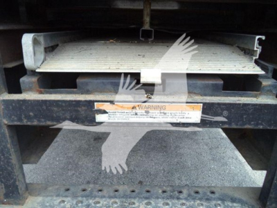 Hino 268a refrigerated truck component with metal platform and warning label visible