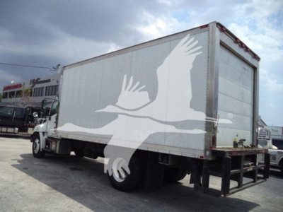 2015 Hino 268a refrigerated truck with box; side shows large white bird graphic overlapping the trailer; rear doors closed; VIN and stock info not visible on image
