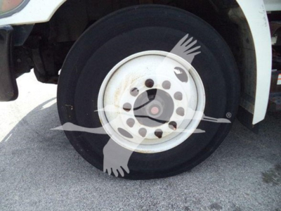 Hino truck wheel and front tire with partial fender; no readable labels or text visible on the wheel area.
