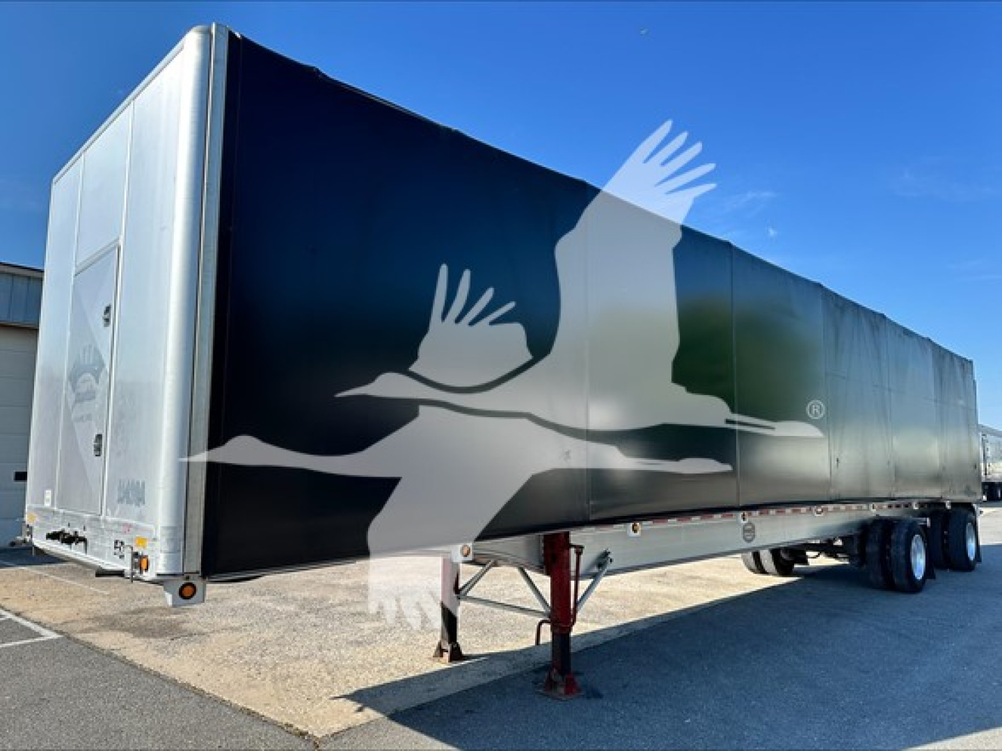 Curtainside trailer showing 2013 Mac Alum Flat with silver/black paint, side logo crane silhouette, front hitch and landing legs visible.