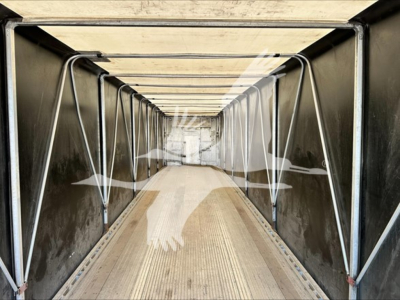Trailer interior showing aluminum side rails and corrugated floor in a curtainside Mac aluminum flatbed trailer.