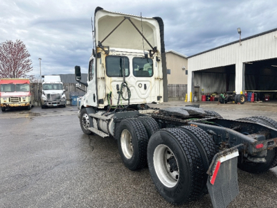 Freightliner Cascadia 116 daycab rear view showing chassis and dual rear axles with fifth wheel and exposed drivetrain components.