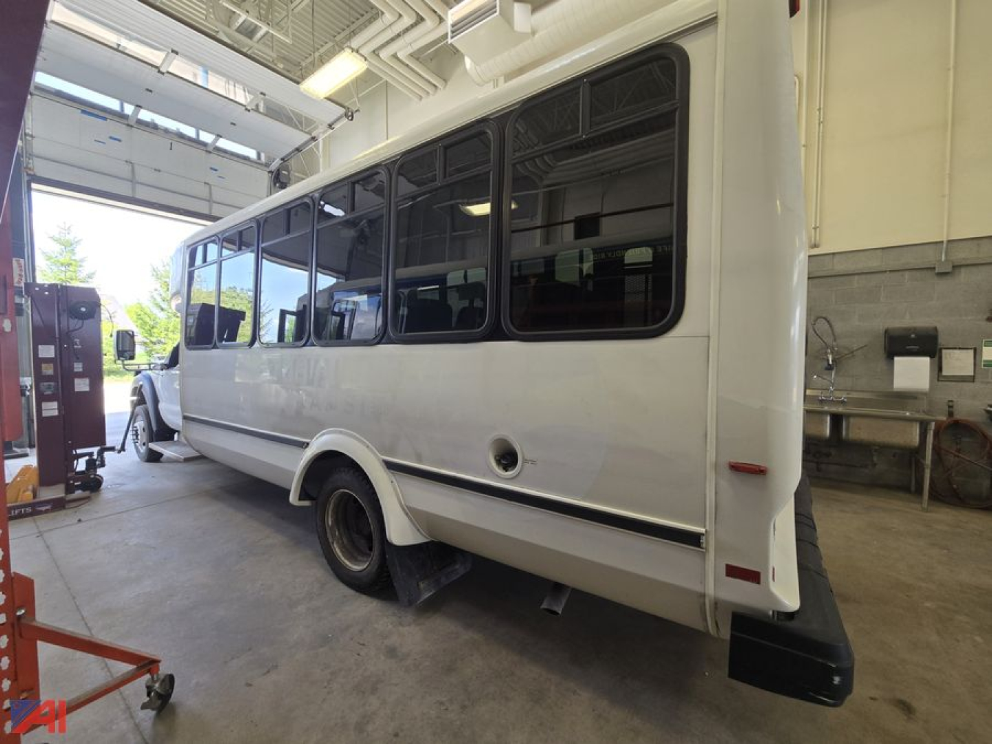 Bus exterior 2016 Ford F550 Super Duty Bus side/rear view showing large windows and white body.