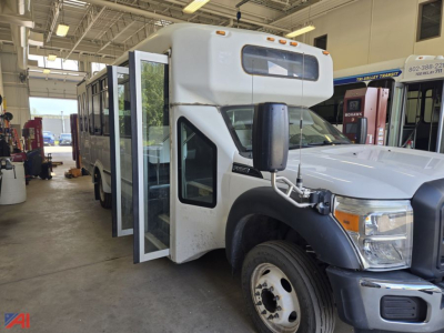 Ford F550 Super Duty bus interior doorway and front cab, side view showing bus door open.