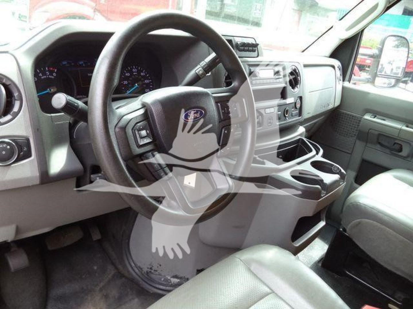 Ford E-350 interior dashboard and steering wheel view showing center console and cup holders.