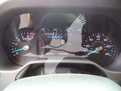 Dashboard of a 2022 Ford E350 XL SD showing speedometer and tachometer with digital display reading 0 mph and PRNDM21 gear indicator.