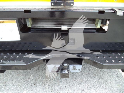 Ford E-350 XL SD rear view showing hitch and step bumper with black spare area.