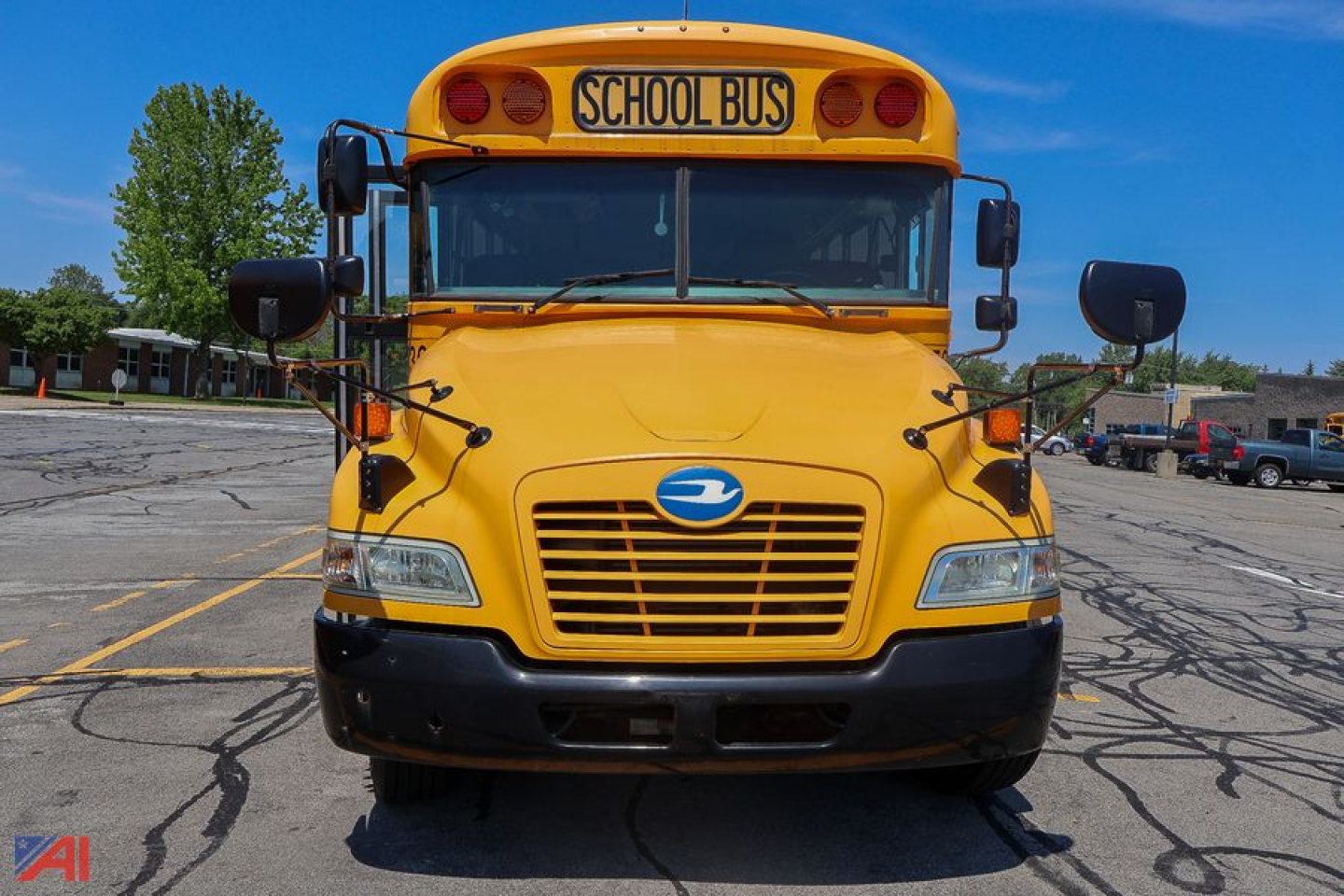 Front view of a 2018 Blue Bird Vision mid-size school bus in yellow with 'SCHOOL BUS' sign, grille, headlights, large windshield, and side mirrors.