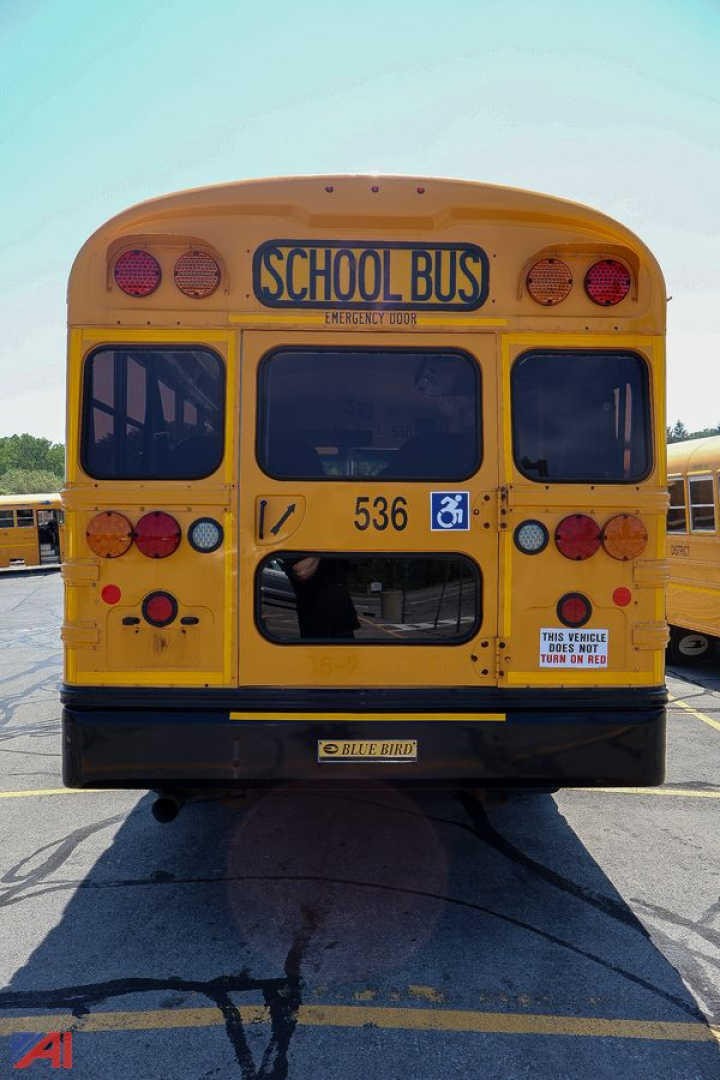 Rear view of a yellow school bus with 'SCHOOL BUS' sign, wheelchair accessibility symbol, and number 536.