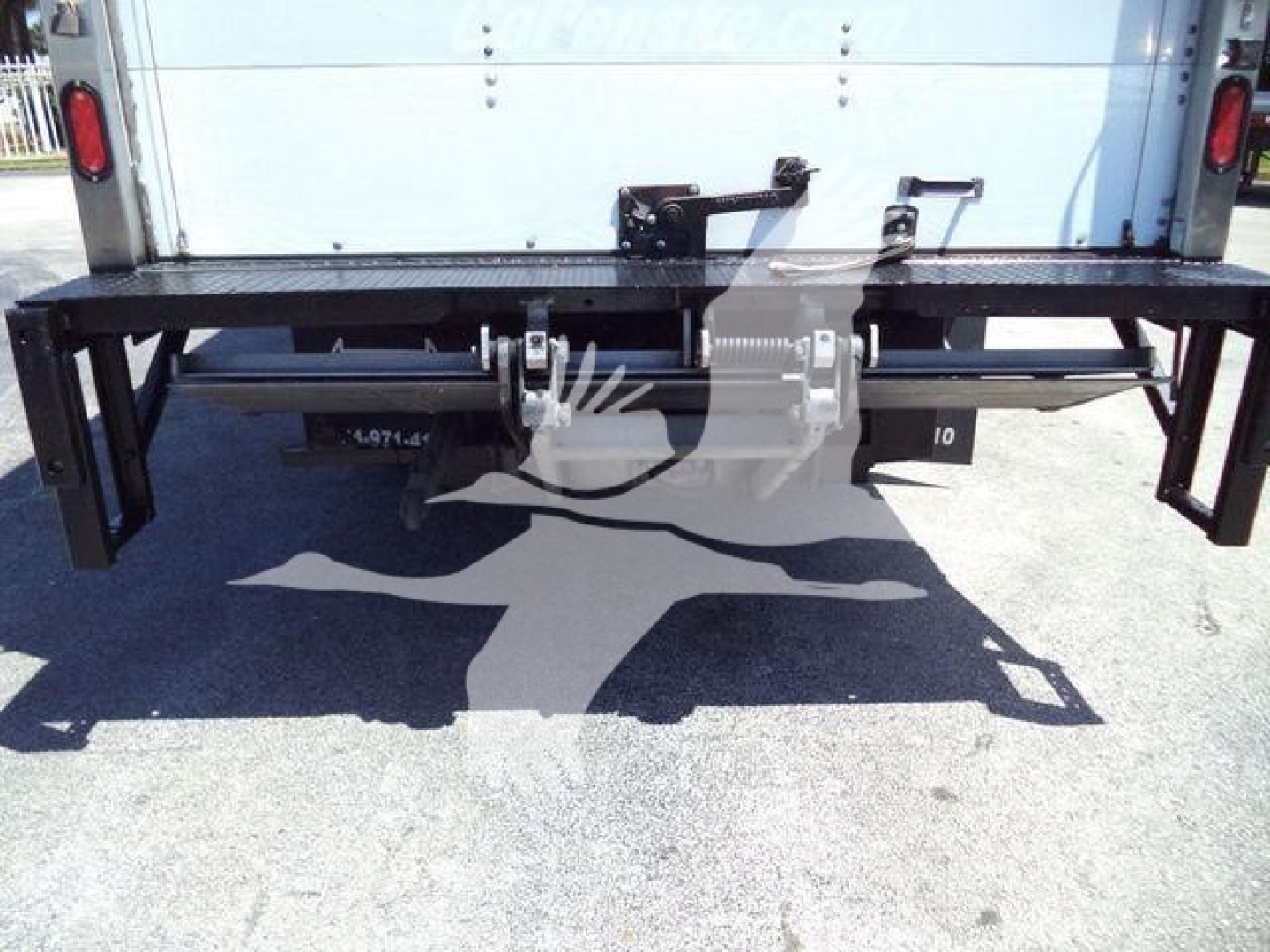 Rear view of a 2020 Isuzu NPR HD box truck showing the flat rear bumper and undercarriage components.