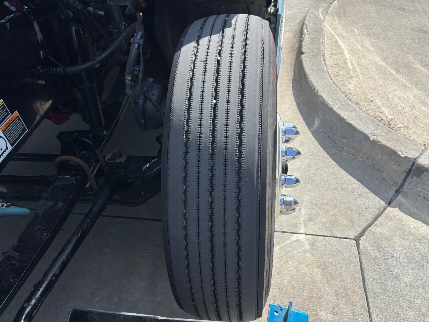 Kenworth T680 wheel/view showing front steer tires and wheel studs.