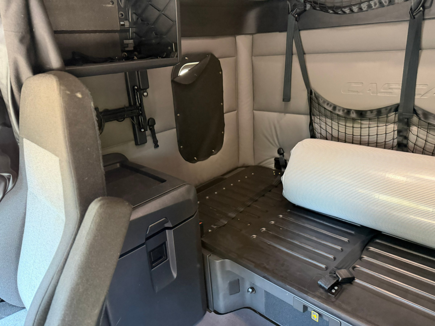 Cab interior of a Freightliner PT126064ST sleeper truck showing a fold-down bunk mattress and side wall panels.