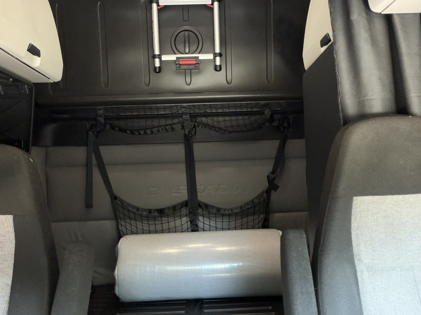 Freightliner PT126064ST cab interior showing storage nets and a cylindrical cushion in the sleeper area.