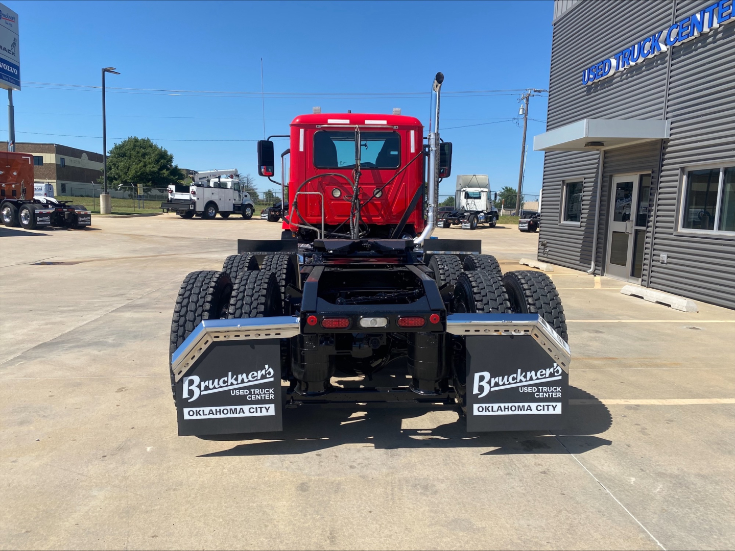 Back view of a red 2021 Mack Anthem truck tractor showing dual rear axles and mud flaps with Bruckner’s Oklahoma City branding.