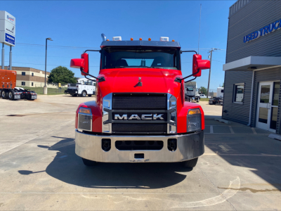 Front view of red 2021 Mack Anthem conventional day cab truck showing large black Grille with MACK logo, chrome bumper, side mirrors, and headlights.