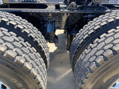 Rear view of a Mack ANTHEM tandem tractor chassis showing dual rear axles and suspension components.