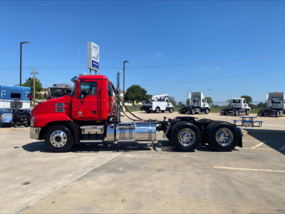 Red 2021 Mack ANTHEM heavy duty truck tractor side view showing cab, chrome fuel tanks, and dual rear axles with six wheels.