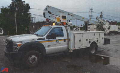 Ford F-550 bucket truck with boom lift and service body, front view, side marking UNIT 13, utility decals.